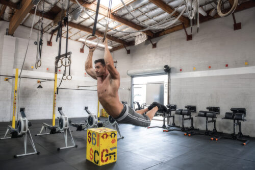 Chris Keith coaching a teen on lifting form in his San Diego studio, showing why weight lifting is safe for teens with supervision